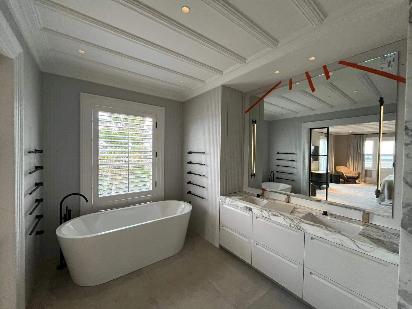 Bathroom with a freestanding bath, marble vanity and a painted timber batten ceiling
